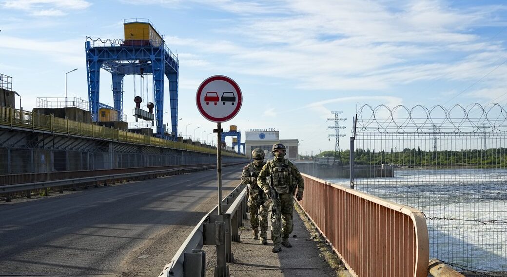 Russian troops patrol an area at the Kakhovka Hydroelectric Station, a run-of-river power plant on the Dnieper River in Kherson region, south Ukraine, Friday, May 20, 2022. The Kherson region has been under control of the Russian forces since the early days of the Russian military action in Ukraine. This photo was taken during a trip organized by the Russian Ministry of Defense. (AP Photo)